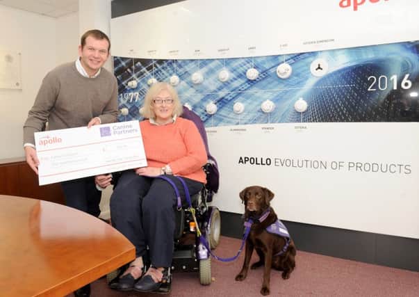 Peter Browitt, finance director, presenting the cheque to Pam Quick and her dog Alucia on behalf of Canine Partners 

Picture: Sarah Standing