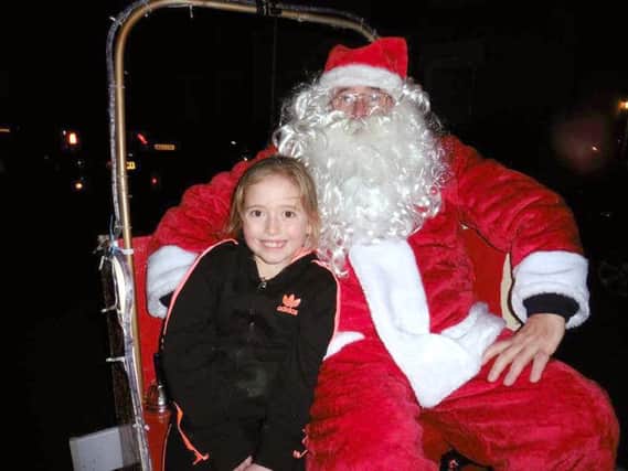 Youngster Dolly-Ana Norrish enjoys last years Santa sleigh run in Gosport