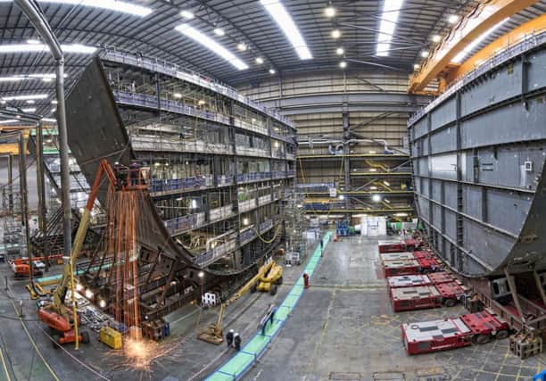 Picture of HMS Prince of Wales, the second of the Royal Navy's Queen Elizabeth Class aircraft carriers, having its F and G ring sections joined together at BAE Systems' shipbuilding bay within Portsmouth Naval Base.