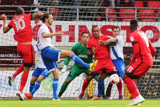 Up for the battle: Christian Burgess and Michael Doyle in action against Leyton Orient this season Picture: Joe Pepler