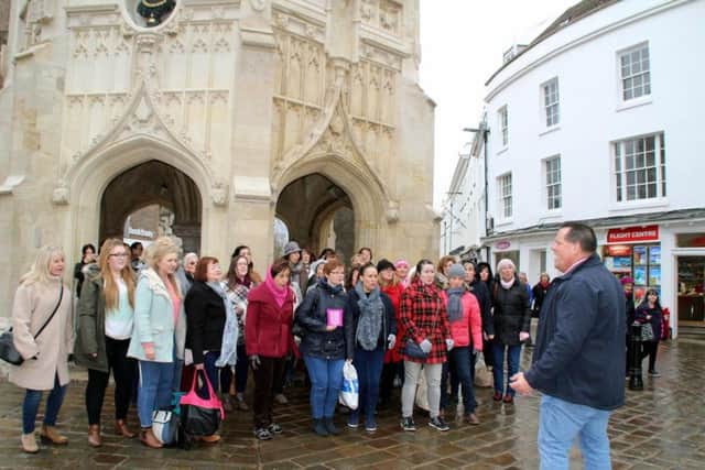 Members of the Spinnaker Chorus sing for shoppers in Chichester city centre