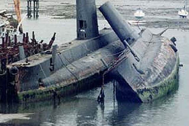 Touching farewell: Otus at John Poundss scrapyard supports a sister ship, believed to be HMS Onslaught, before being towed away