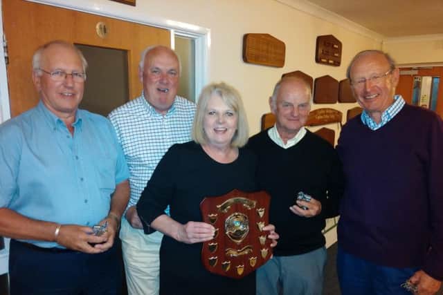 Linda Cleeve, wife of the late Joss Cleeve, presents the trophy to the Horse and Jockey team