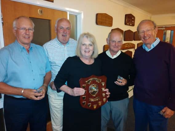 Linda Cleeve, wife of the late Joss Cleeve, presents the trophy to the Horse and Jockey team