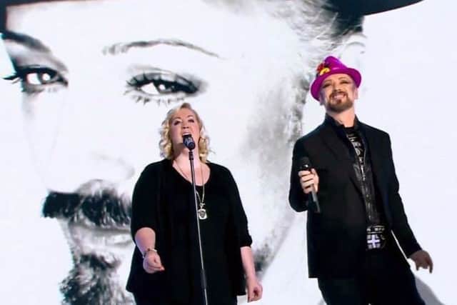 Amba Tremain on stage performing with Boy George