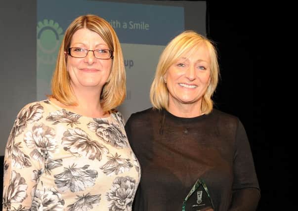 Linzi Stean from Colas (left) presents the runner-up award in Service With A Smile to Jane Hall