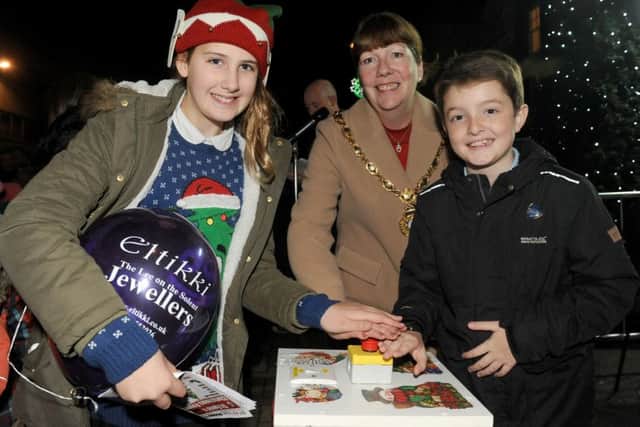Mayor of Gosport Lynn Hook with head girl Willow McAlister  and head boy Joseph Turner from Lee-on-the-Solent Junior School, turning on the town's Christmas lights Picture: Sarah Standing (161614-7807)