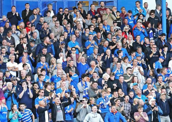 Pompey fans on their feet for the recent game against Doncaster Rovers Picture: Joe Pepler