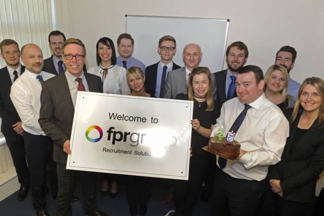 Mark Foster, left at the front, and joint owner Paul Simpson, holding the cake, and the staff at FPR Group Recruitment in Havant celebrate their 25th year in business Picture Ian Hargreaves (161340-1)