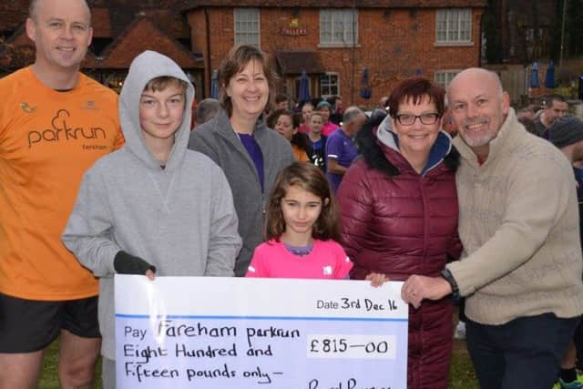 Jeff Clark, right, makes the donation to Fareham parkrun. Also pictured, from left: John Salt, Daniel Booker, Kathy O'Loughlin, Bella Emmonds and Michelle Clark