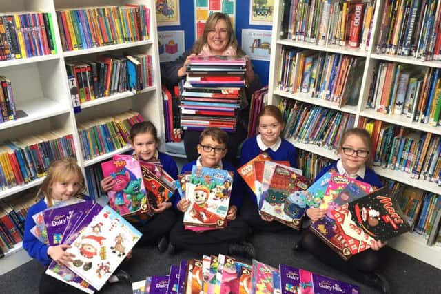 Sophie Parkinson, Evie Mulhall, Lewis Jack, Emily Slight and Brooke Gibson with Pam Hibbard from Caring Hands, handing over the Advent calendars they have collected