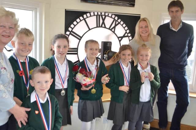 The Clock Tower owners and schoolchildren with winner Francesca Nice, centre