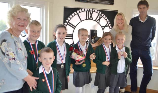 The Clock Tower owners and schoolchildren with winner Francesca Nice, centre