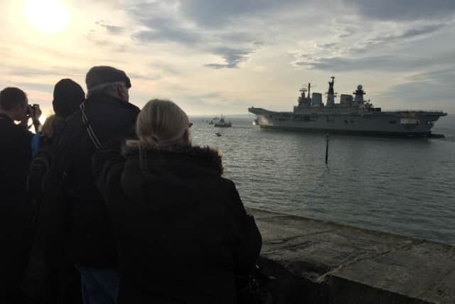 Crowds gather at the Round Tower in Old Portsmouth to say goodbye to Illustrious. Picture: Tom Cotterill PPP-160712-112753001