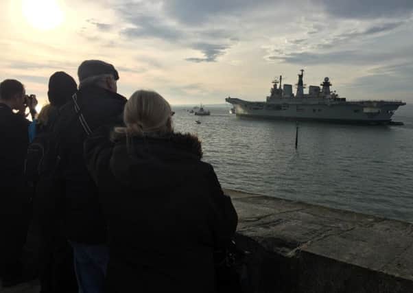 Crowds gather at the Round Tower in Old Portsmouth to say goodbye to Illustrious. Picture: Tom Cotterill PPP-160712-112753001