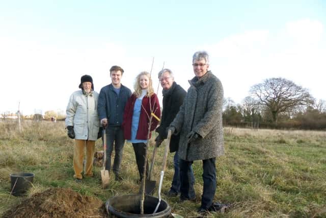 Bill and Louise Jones, right, plant a tree in memory of son Tom, with their daughter Kitty Jones, centre, friend Will Prior, and Toms grandfather Laurie Vinten, far left, in the orchard