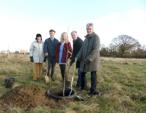 Bill and Louise Jones, right, plant a tree in memory of son Tom, with their daughter Kitty Jones, centre, friend Will Prior, and Toms grandfather Laurie Vinten, far left, in the orchard