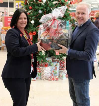 Mandi Myers, Tesco community champion with Rev Mark James with one of the food hampers