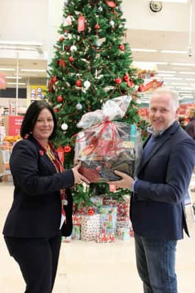 Mandi Myers, Tesco community champion with Rev Mark James with one of the food hampers