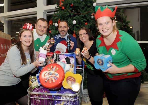 From left, Tesco Fratton's clothing manager Philippa Smith, fresh lead Ryan Faulkner, store manager Jon Roberts, customer services manager Sally Noice and community champion Gemma Morrison Picture: Sarah Standing (161624-8392)