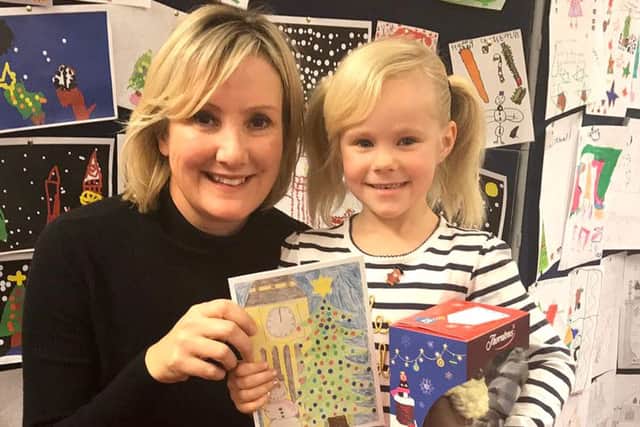 Gosport MP Caroline Dinenage with Christmas card competition winner Nevaeh-Rose MacLennan