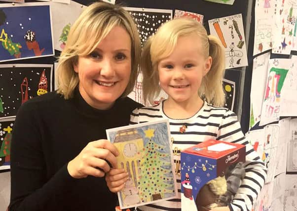 Gosport MP Caroline Dinenage with Christmas card competition winner Nevaeh-Rose MacLennan