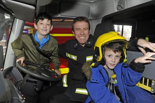 Connor, 12, firefighter Geoff Doughty and Elijah, 11  Picture Ian Hargreaves  (161355-3)