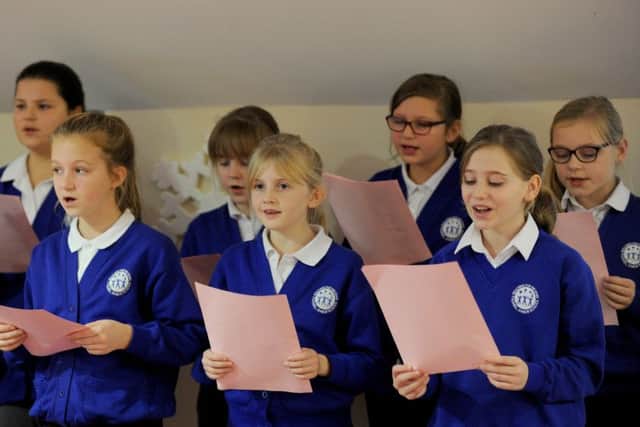 Children from Padnell Junior School singing Christmas carols for the volunteers at the Rowans Hospice. Front from left, Imogen Collen, 10, Olivia Fowler, 10, and Emma Pinhorne, 10Picture: Sarah Standing (161633-4761)