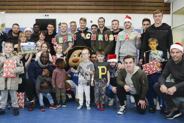 The Pompey players brought some Christmas cheer to the children at Queen Alexandra Hospital yesterday with a visit to the paediatric ward, where they handed out presents and selection boxes Picture: Portsmouth Hospital NHS Trust