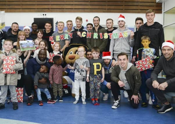 The Pompey players brought some Christmas cheer to the children at Queen Alexandra Hospital yesterday with a visit to the paediatric ward, where they handed out presents and selection boxes Picture: Portsmouth Hospital NHS Trust