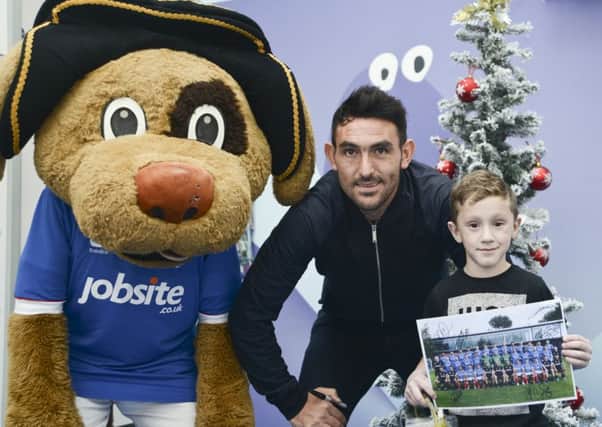 From left, Nelson the mascot, Pompey's Gary Roberts, and Jude Allen, six, at Queen Alexandra Hospital in Cosham