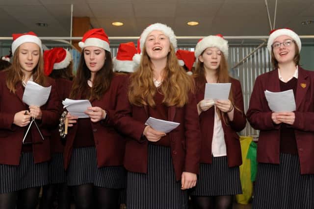 Year 11 girls from Portsmouth High School at Queen Alexandra Hospital, including Francesca McBride, 15, centre, who also sang a solo Picture: Sarah Standing (161696-8920)