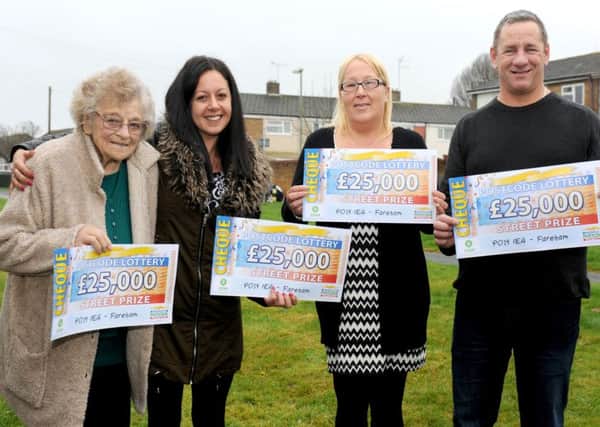 Patricia Jarman, Sasha Geddei-Nabbei, Lorraine Lawton and Martin Ray with their Â£25,000 cheques