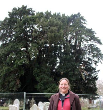 The Rev Jenny Gaffin in front of the treasured yew