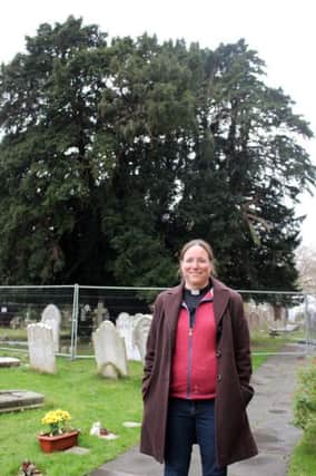 The Rev Jenny Gaffin in front of the treasured yew