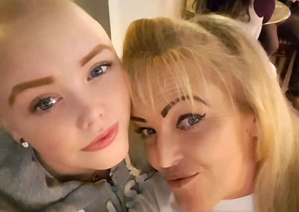 Saraya Jeffery, 14, from Buckland, shows off her new look with her mother Lorraine after having her head shaved
