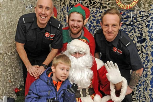 From left, firefighter Phil Jackson, Colin Webb and firefighter Mitch Creighton with Santa and Alexander Barnes from Portchester, eight Picture: Ian Hargreaves (161364-3)