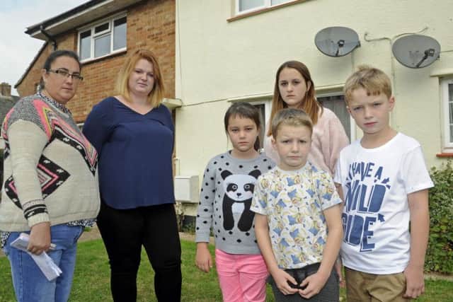 Tracy Stinton, left, with fellow navy wife Lucy Stigar and their children, from left,, Rhianan and Jasmine Stinton with Alfie and Harvey Stigar outside Tracy's former MoD house in Gosport
