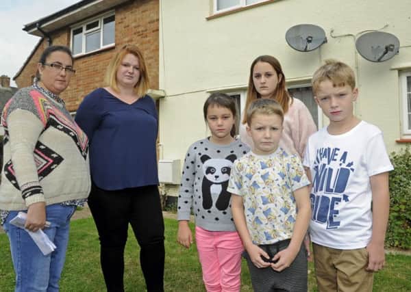 Tracy Stinton, left, with fellow navy wife Lucy Stigar and their children, from left,, Rhianan and Jasmine Stinton with Alfie and Harvey Stigar outside Tracy's former MoD house in Gosport