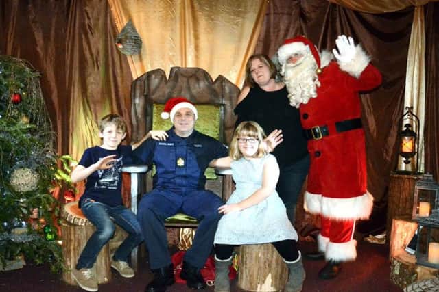 Chris Tisdell was reunited with his wife Helen and children, Lois, and Ewan,at Santa's Grotto at Marwell Zoo. DEFENCE_Santa_224074.JPG