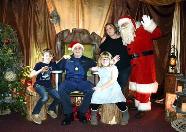 Chris Tisdell was reunited with his wife Helen and children, Lois, and Ewan,at Santa's Grotto at Marwell Zoo. DEFENCE_Santa_224074.JPG