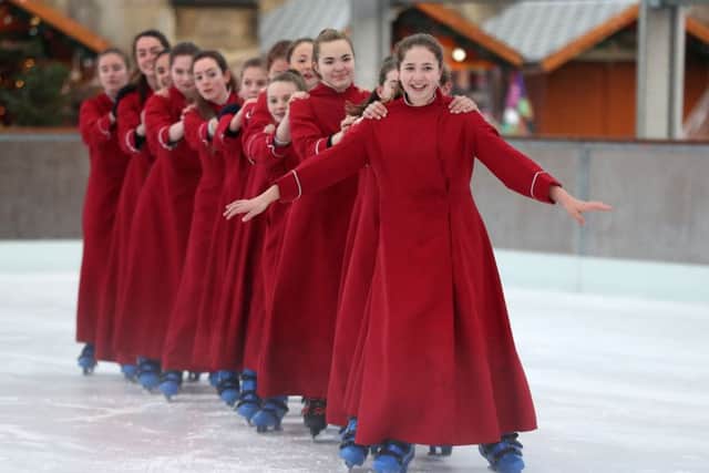 The Girl Choristers of Winchester Cathedral Choir skate on the cathedral's ice rink