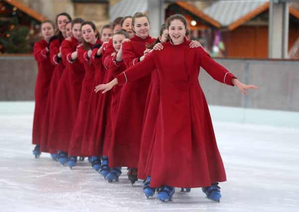 The Girl Choristers of Winchester Cathedral Choir skate on the cathedral's ice rink
