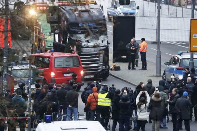 Media people stand near a truck which ran into a crowded Christmas market killing several people Monday evening in Berlin, Germany, Tuesday, Dec. 20, 2016. Picture: AP Photo/Markus Schreiber