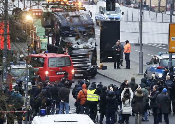 Media people stand near a truck which ran into a crowded Christmas market killing several people Monday evening in Berlin, Germany, Tuesday, Dec. 20, 2016. Picture: AP Photo/Markus Schreiber