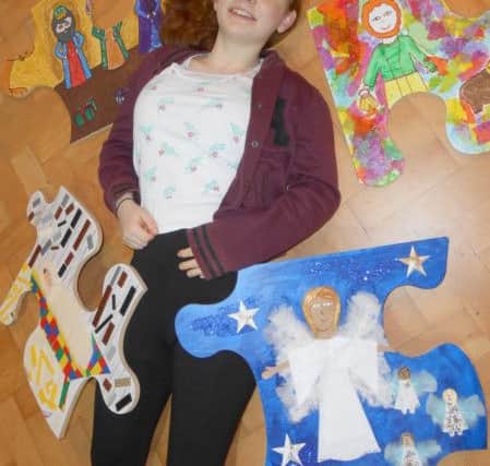 Alex Lemieux with giant nativity jigsaw pieces which will be put together on Christmas Eve