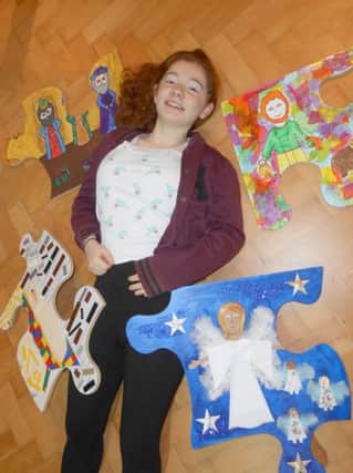 Alex Lemieux with giant nativity jigsaw pieces which will be put together on Christmas Eve