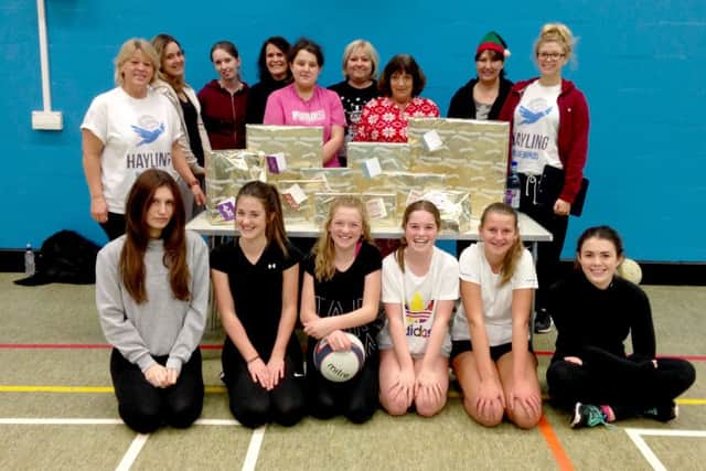 Players from Hayling Bluebirds netball team pictured with some of the presents they bought for families who are struggling