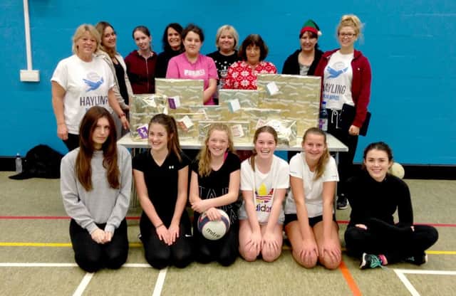 Players from Hayling Bluebirds netball team pictured with some of the presents they bought for families who are struggling