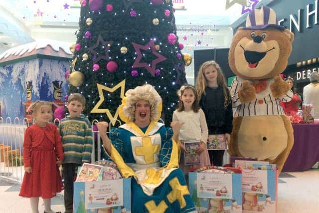 Winner Emilie-May Clifton, with brother Oskar, Mark Siney as Nurse Nellie, winner Lily Thompson and third winner Ruby-Mae Puddick, Fareham Shopping Centres Toffee Bear and their bags of toys